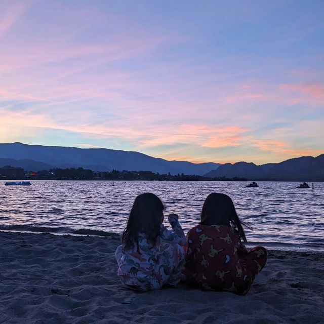 Children enjoying the beach at sunset in Osoyoos