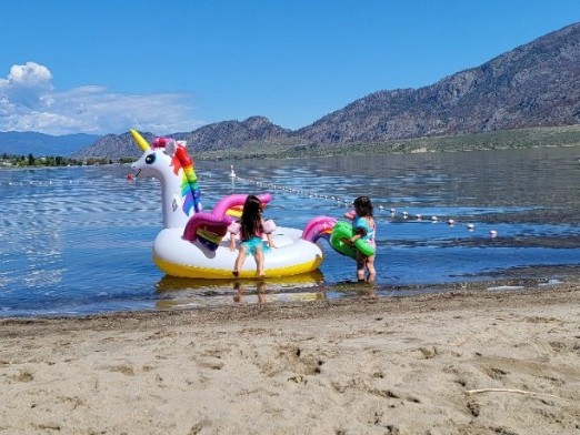 Children playing at the shoreline in Osoyoos